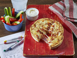 Cheese and tomato pizza severed on a red wooden board 