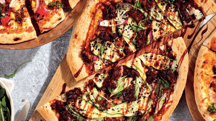 Multiple pizzas on a table